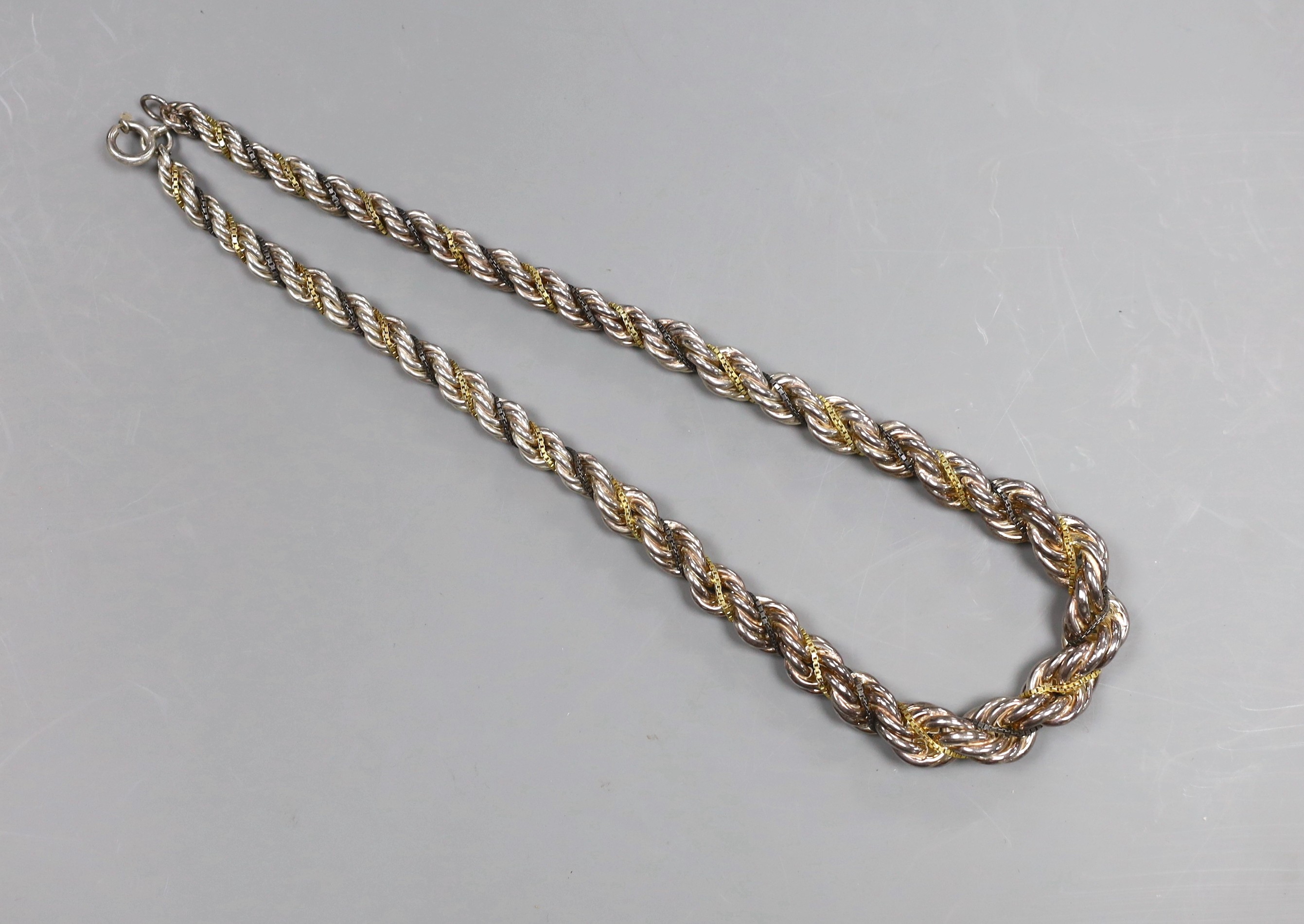 A Continental white metal, gilt and oxidised metal three strand ropetwist chain necklace, 50cm